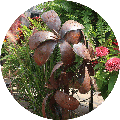 A rusty colored metal flower sculpture.